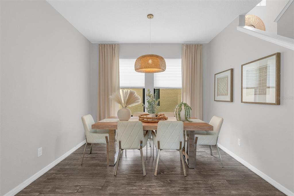 A dining room features a wooden table, six white chairs, and a woven pendant light — 325 PARTRIDGE PEA LANE, OCOEE, FL