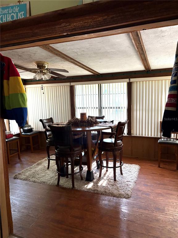 A dining area features a round wooden table with four chairs on a shag rug — 620 N SAVARY AVENUE, INVERNESS, FL