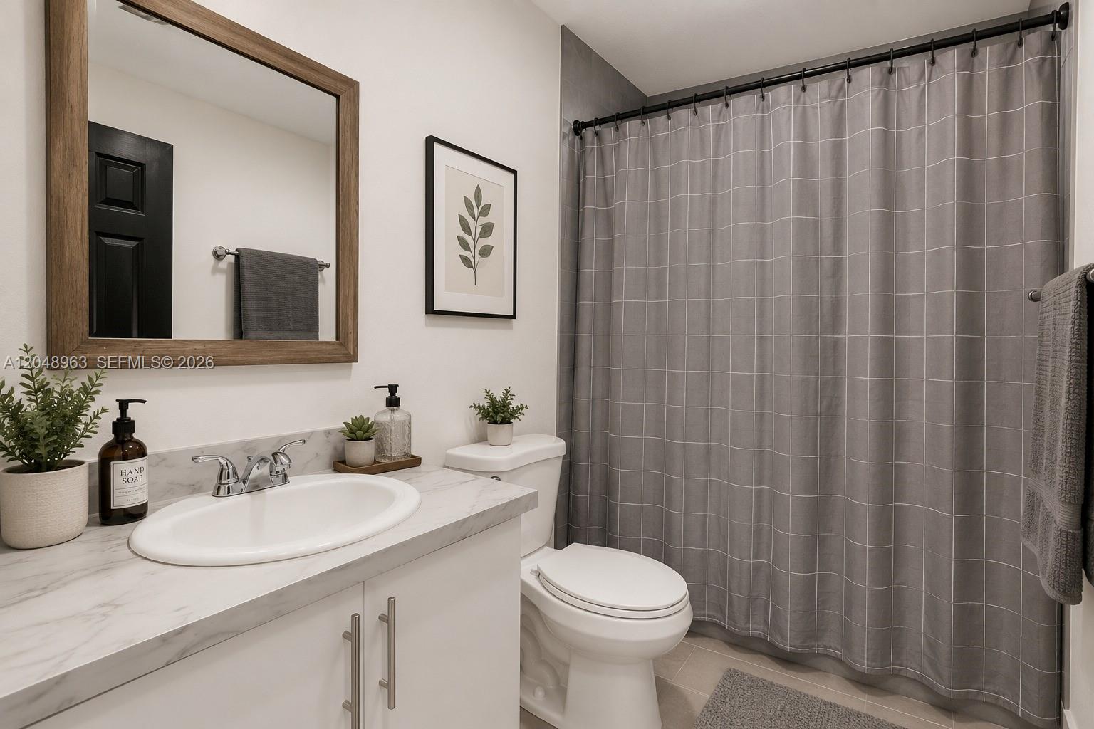 A bathroom features a white vanity with a marble countertop, a toilet, and a shower curtain — 14404 SW 105th Ct, Miami FL 33176, MIAMI, FL