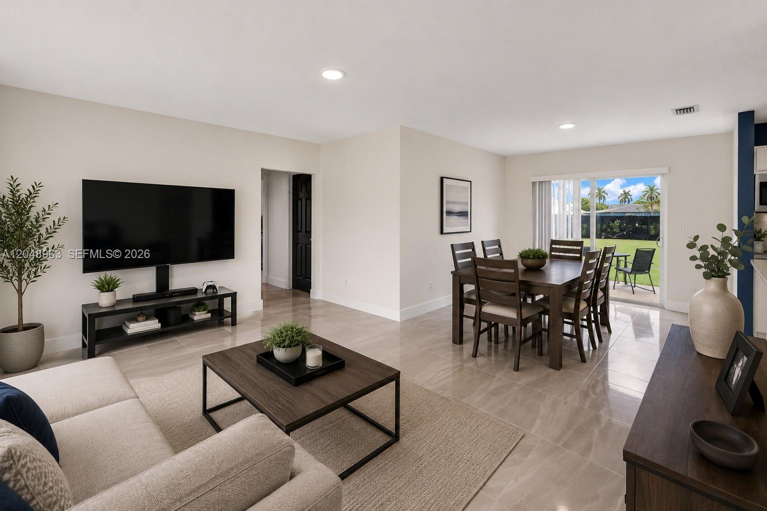 A living and dining area features tile flooring, neutral walls, and a sliding glass door — 14404 SW 105th Ct, Miami FL 33176, MIAMI, FL