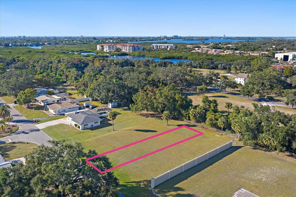 An aerial view shows a vacant rectangular lot outlined in pink next to a house — SOUTHWOOD STREET, SARASOTA, FL