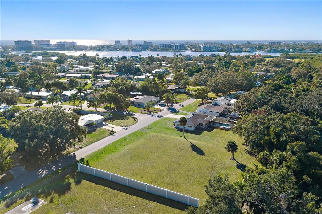 An aerial view shows a large grassy lot, a residential house, and surrounding neighborhood greenery — SOUTHWOOD STREET, SARASOTA, FL