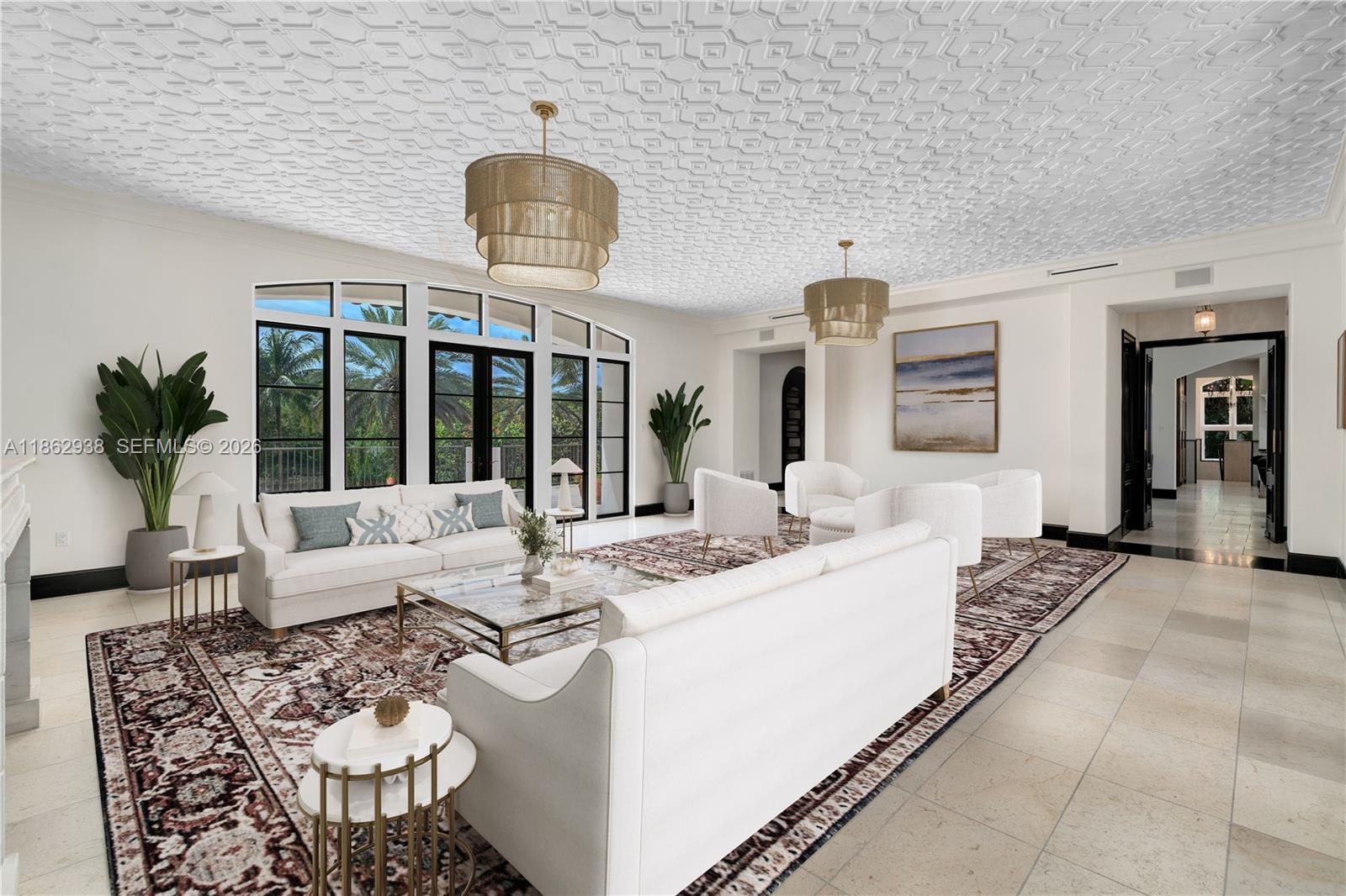 A bright living room features a patterned ceiling, two chandeliers, white sofas, and large windows — 3305 S Moorings Way, Miami FL 33133, MIAMI, FL