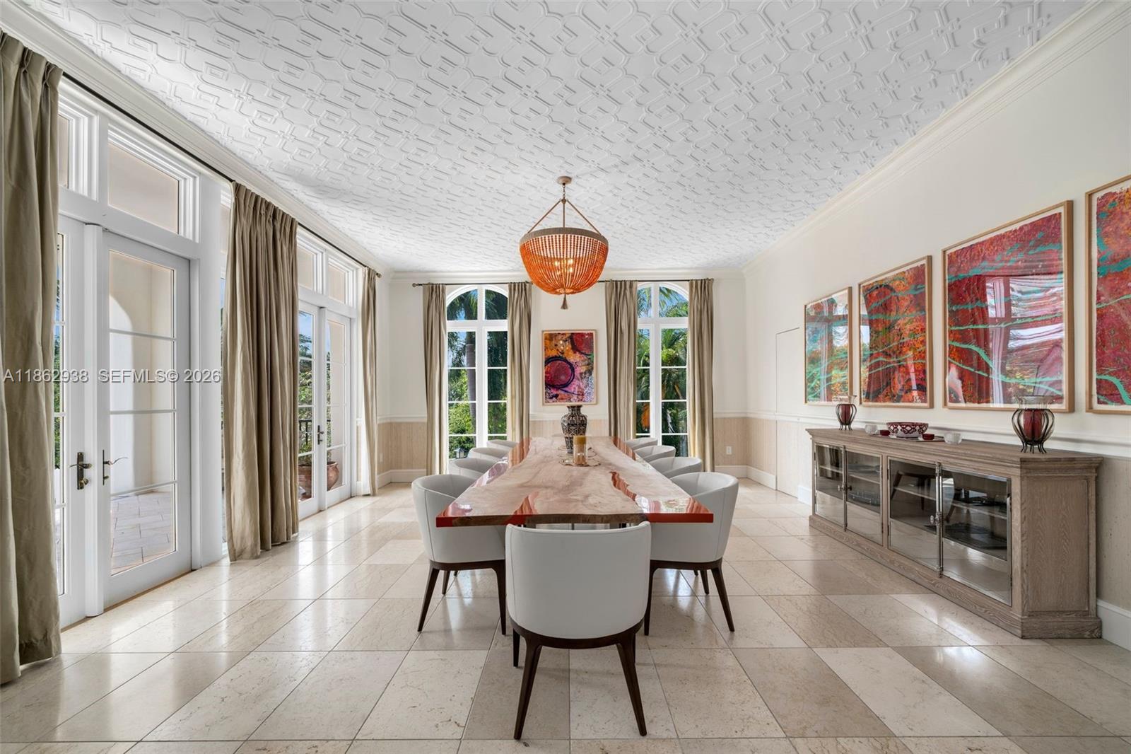 A formal dining room features a live-edge table, white chairs, and a patterned ceiling — 3305 S Moorings Way, Miami FL 33133, MIAMI, FL