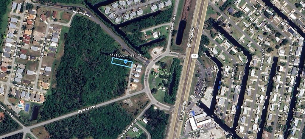 This is an aerial map view showing a rectangular property lot highlighted in blue — 4471 BUCKWHEAT ROAD, PORT CHARLOTTE, FL