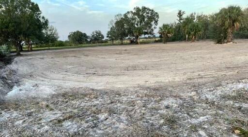 A large, cleared, sandy lot with scattered trees under a clear sky — 18516 NW 262nd Street, Okeechobee FL 34972, OKEECHOBEE, FL