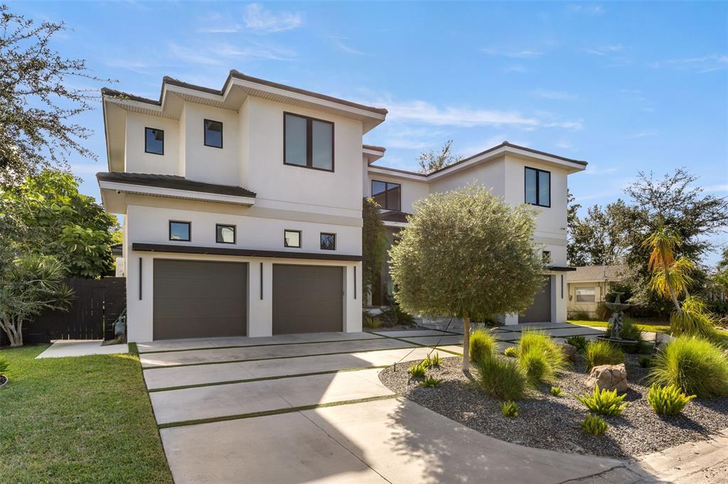 A two-story modern house with a multi-car garage and a landscaped front yard — 4924 W SAN RAFAEL STREET, TAMPA, FL