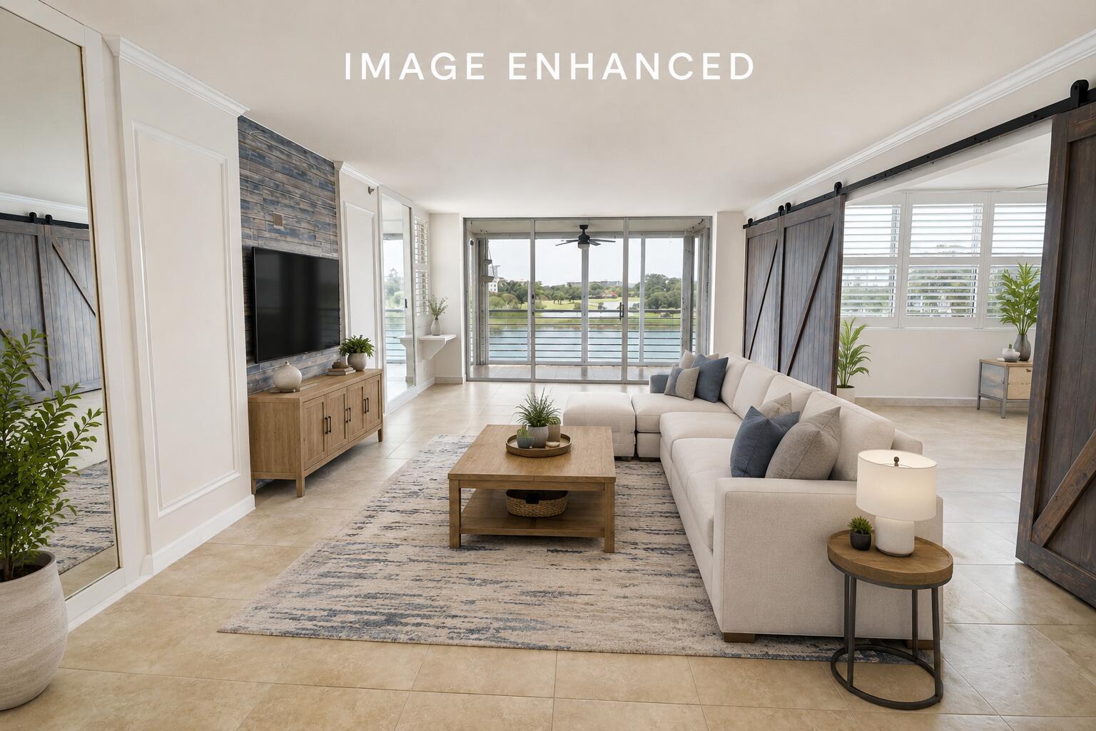 A living room features a sectional sofa, a wood coffee table, and a water view — 3095 N Course Drive # 409, Pompano Beach FL 33069, POMPANO BEACH, FL