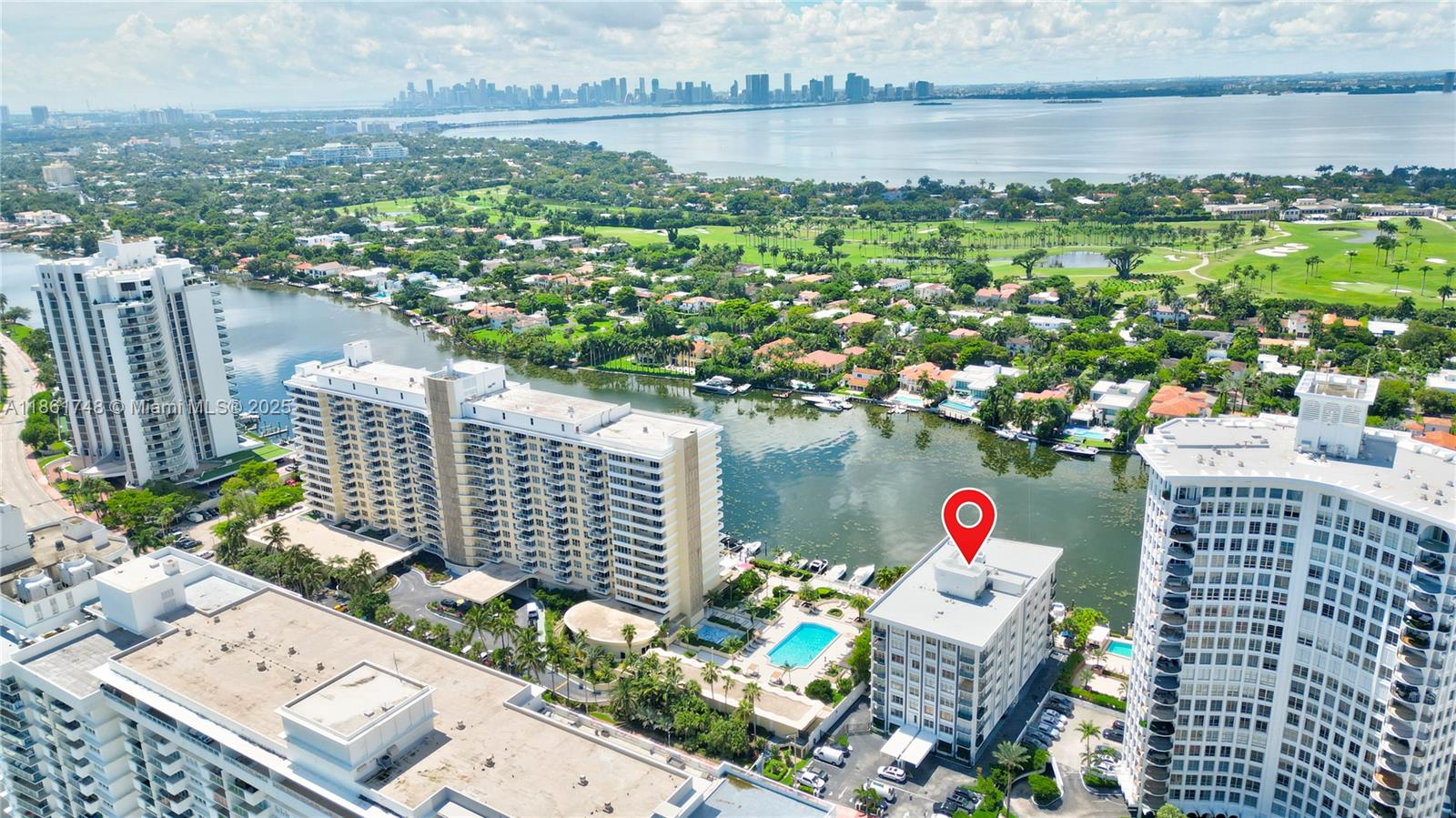 An aerial view shows a mid-rise building marked with a pin near a waterfront pool — 5640 Collins Ave # 6B, Miami Beach FL 33140, MIAMI BEACH, FL