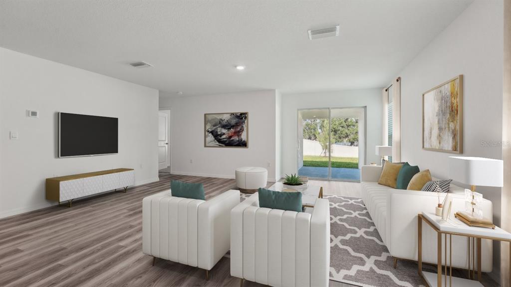 This is a digital rendering of a living room with white furniture and wood-look flooring — 18700 HIGHLAND DEW STREET, SPRING HILL, FL