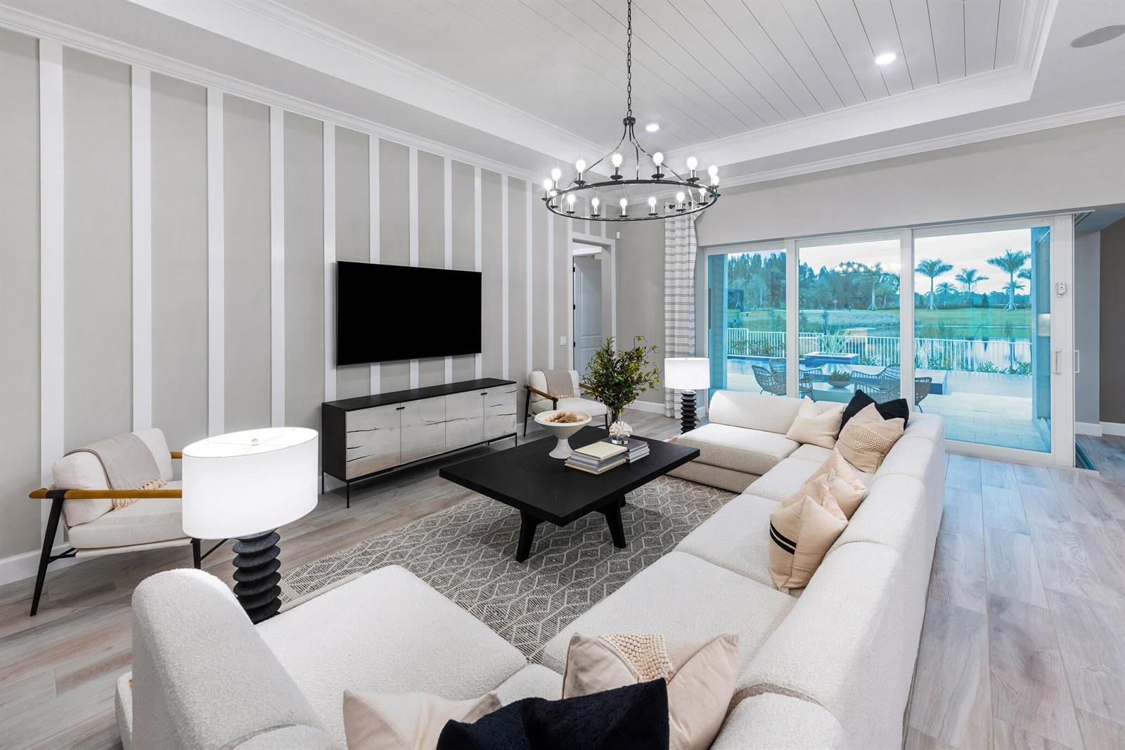 A living room features a large sectional sofa, a striped accent wall, and sliding glass doors — 8225 Nilsa Place # 39, Davie FL 33328, DAVIE, FL