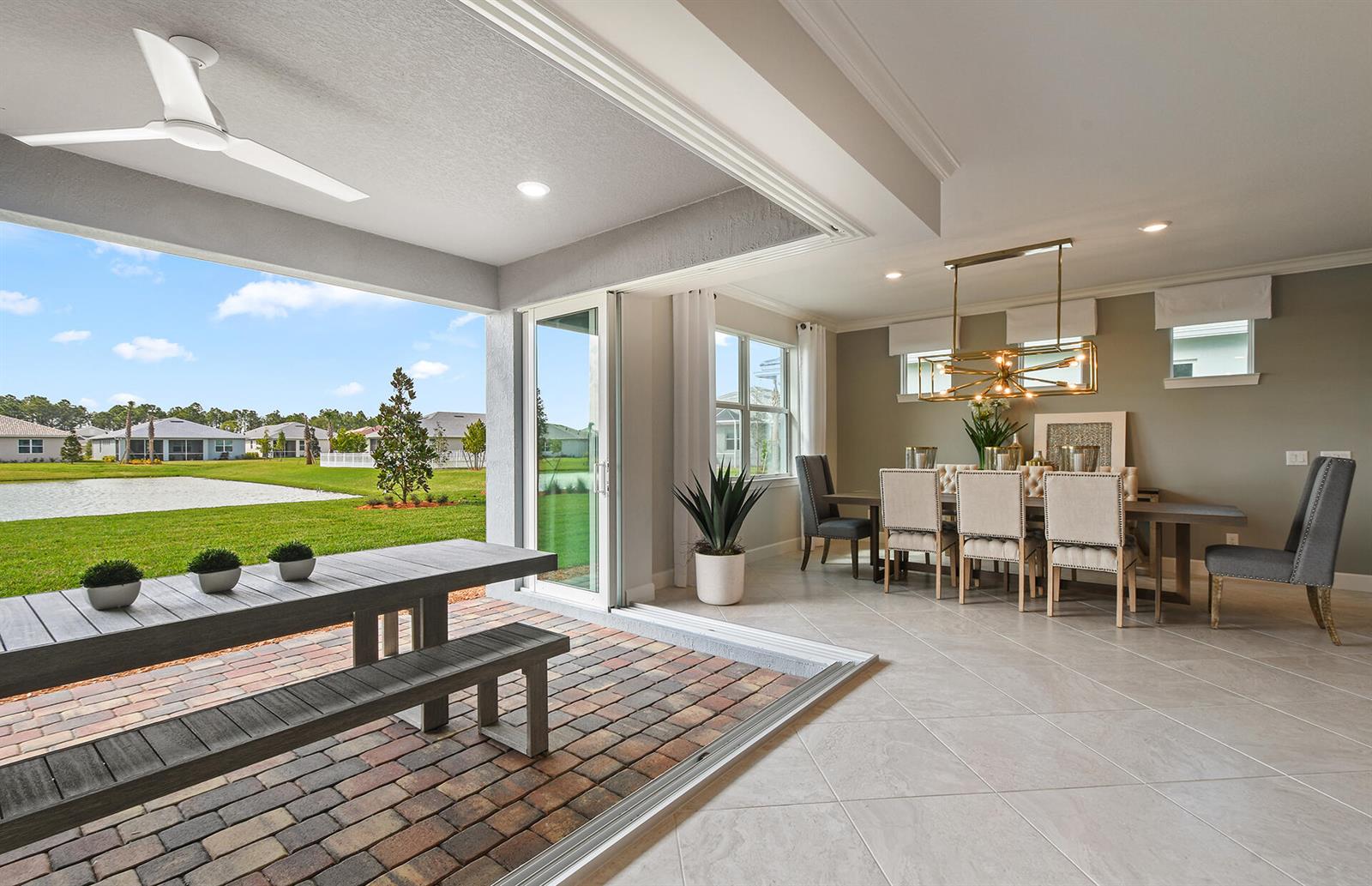 A dining room opens through sliding glass doors to a covered patio with a brick floor — 8225 Nilsa Place # 39, Davie FL 33328, DAVIE, FL