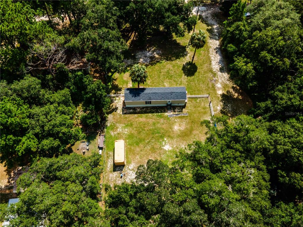 An aerial view shows a rectangular house and a small shed on a wooded lot — 14388 NE 116TH TERRACE, FORT MC COY, FL