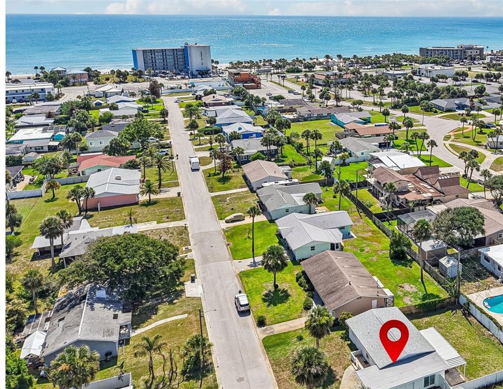 An aerial view shows a residential neighborhood near the beach with a marked house — 160 PONCE DE LEON DRIVE, ORMOND BEACH, FL