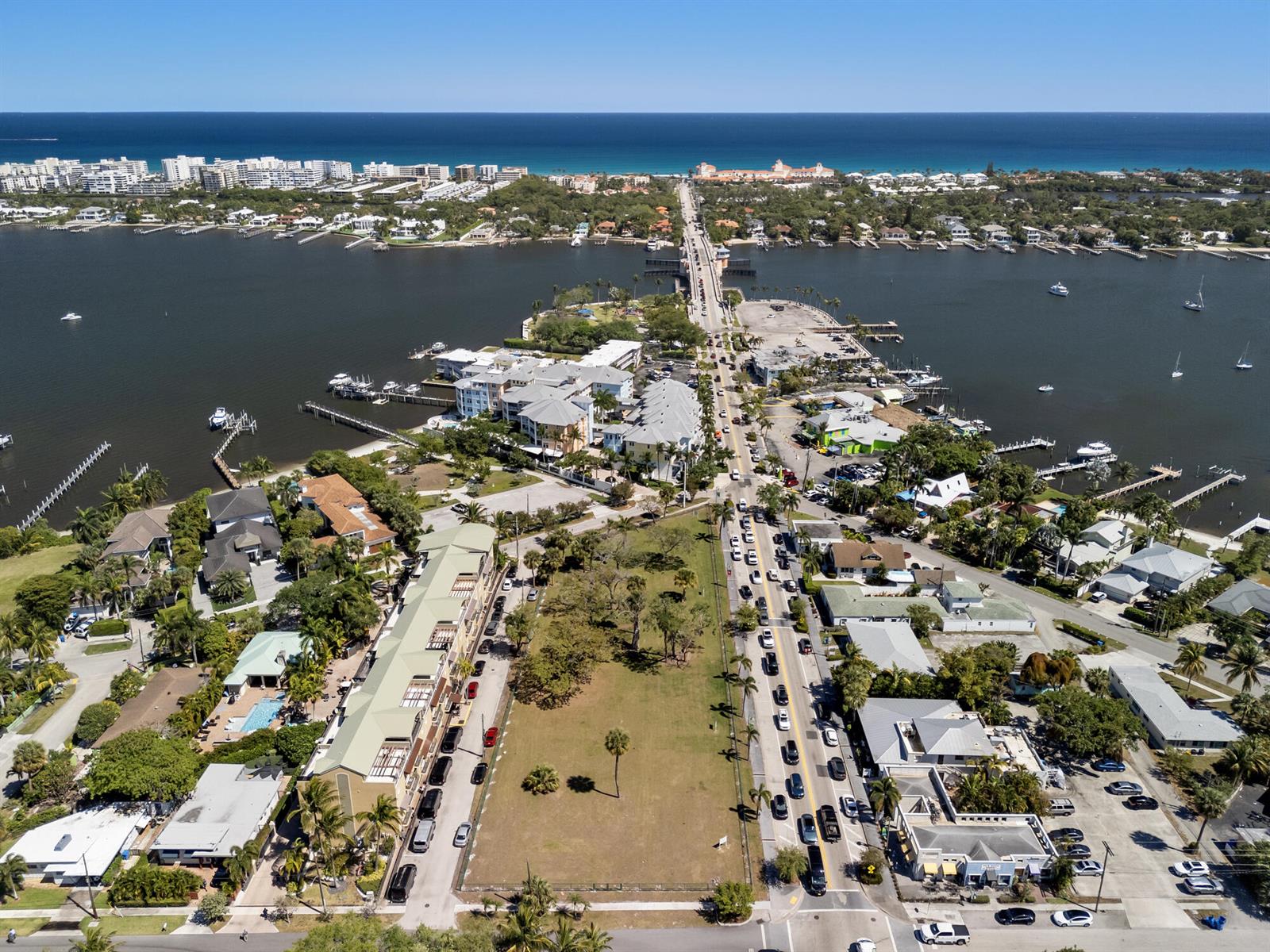An aerial view shows a coastal town with a bridge, waterfront buildings, and a large lot — 201 E Ocean Avenue, Lantana FL 33462, LANTANA, FL