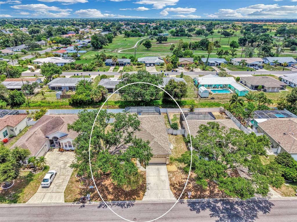 An aerial view shows a single-story suburban house with a driveway and large shade trees — 4327 MANFIELD DRIVE, VENICE, FL