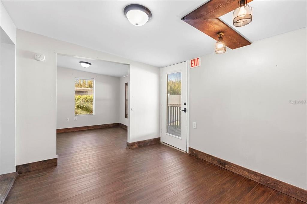 A room with wood-look flooring, a white door, and a wooden ceiling light fixture — 329 FRANKLIN STREET, OCOEE, FL