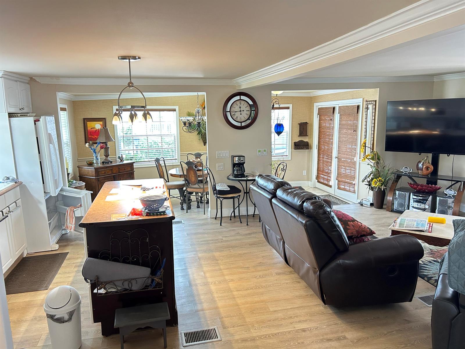 An open-concept living area features a kitchen island, dining space, and a leather sofa — 3348 Florida Street, Hollywood FL 33021, HOLLYWOOD, FL