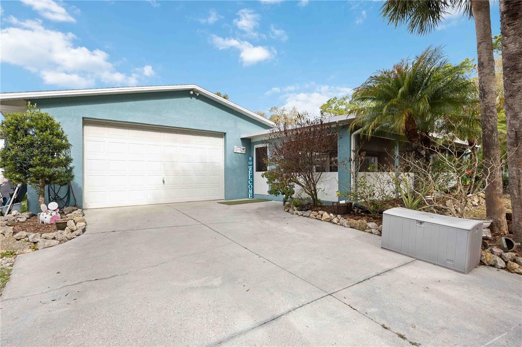 A living room with tile floors, a round rug, ceiling fans, and a Christmas tree — 6649 PIMLICO STREET, NORTH PORT, FL