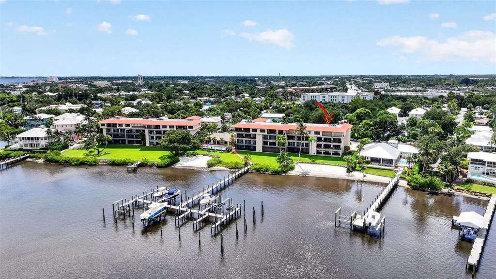 An aerial view shows two multi-story waterfront apartment buildings with docks and boats — 624 SW ST LUCIE CRESCENT UNIT UN208, STUART, FL