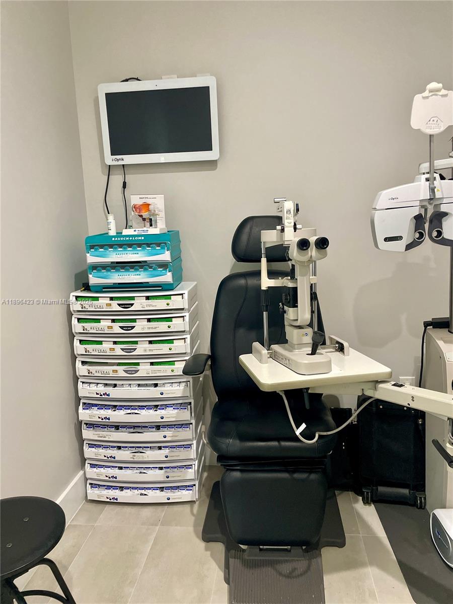 An eye examination room features a patient chair, a slit lamp, and stacked storage drawers — 536 SW 12th Ave, Miami FL 33130, MIAMI, FL
