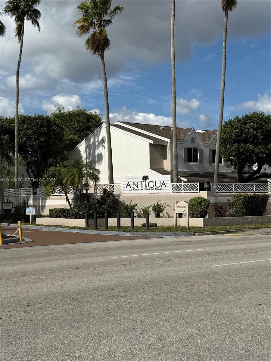 The exterior of the Antigua at Country Club of Miami residential complex features palm trees — 17515 NW 67th Ct # 22, Hialeah FL 33015, HIALEAH, FL