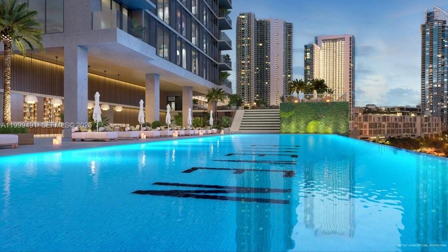 A modern studio apartment features a bed, a small sofa, and a city view — 20 NE 11 St, Miami FL 33132, MIAMI, FL