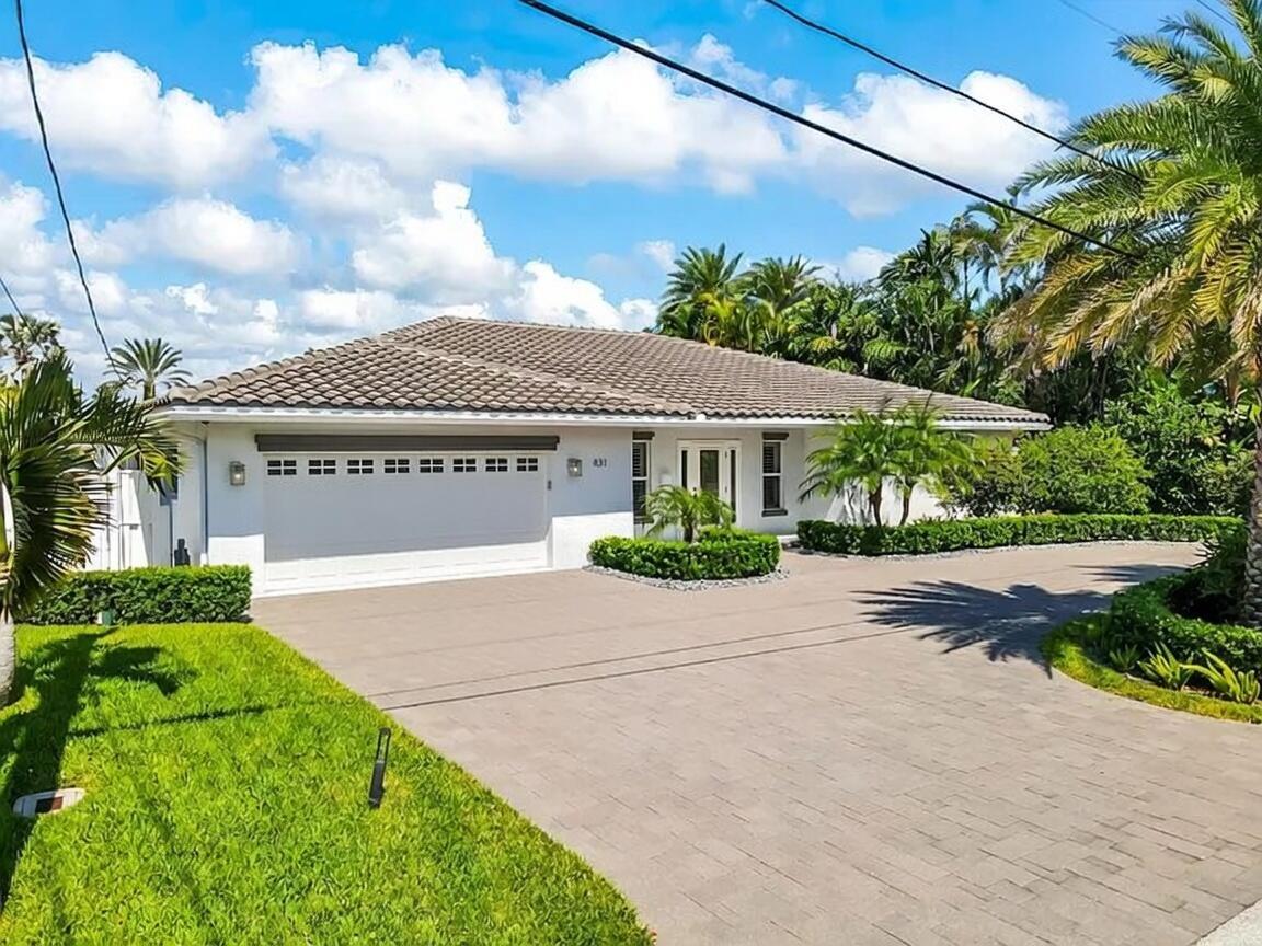 A white single-story house with a tiled roof, a two-car garage, and a paved driveway — 831 Dover Street, Boca Raton FL 33487, BOCA RATON, FL