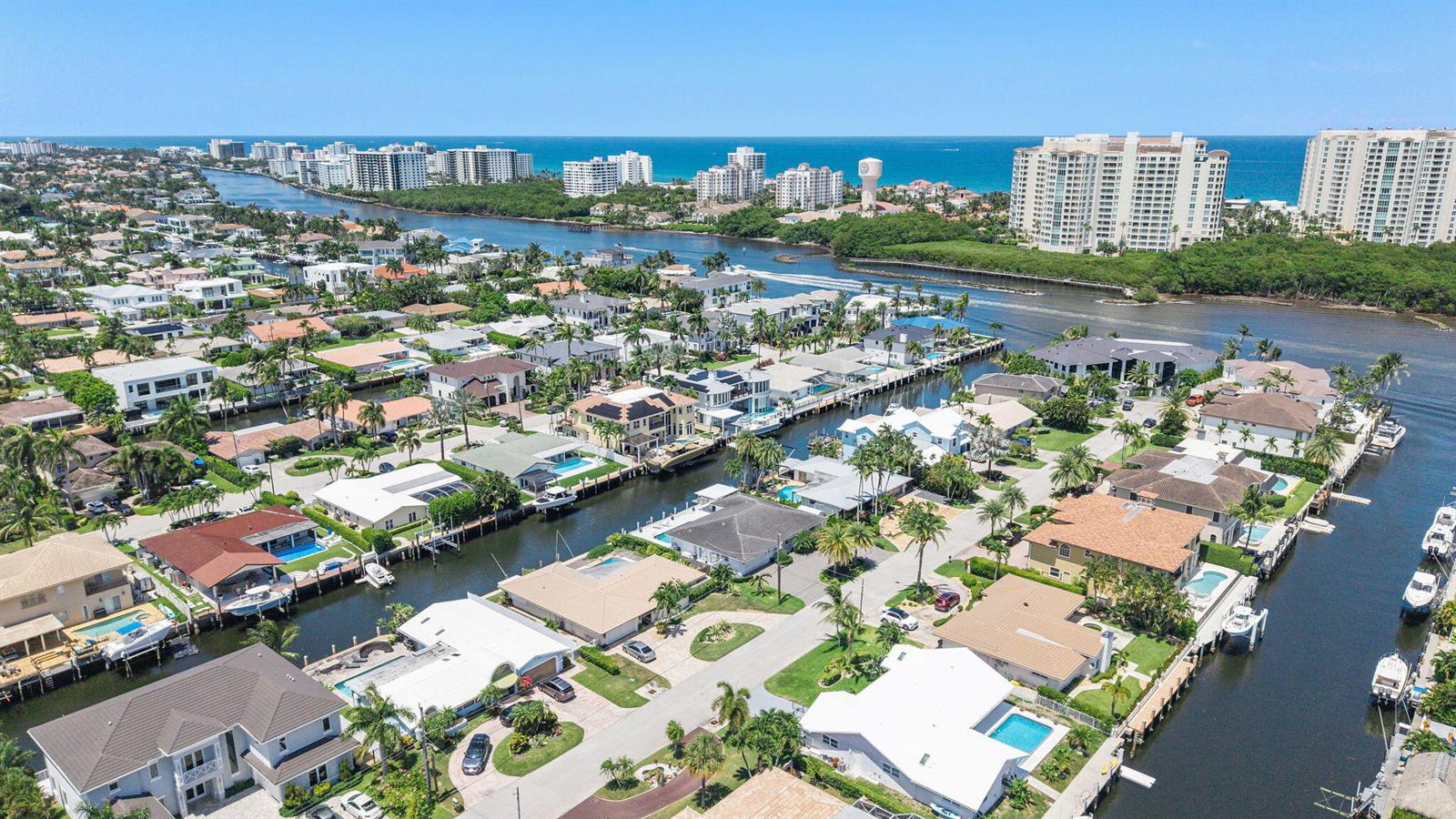 An aerial view shows waterfront houses with private docks along canals leading to the ocean — 831 Dover Street, Boca Raton FL 33487, BOCA RATON, FL