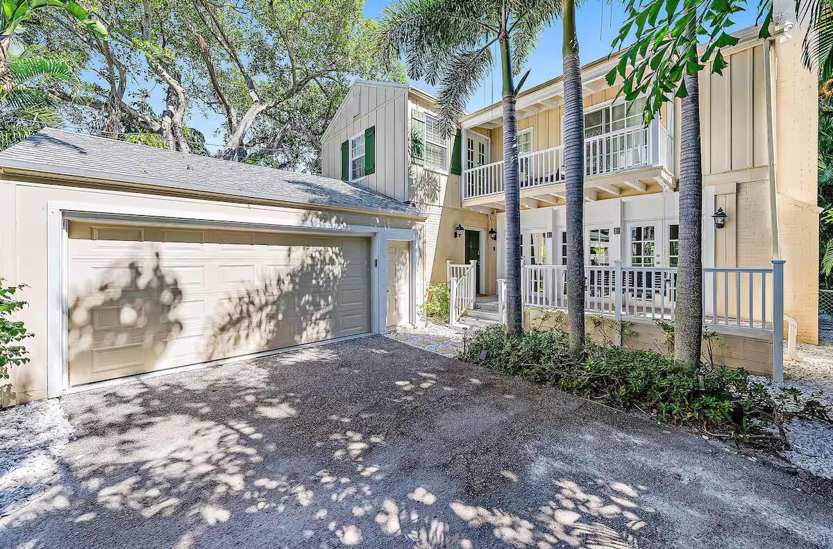 A two-story house with a beige exterior, a gravel driveway, and a two-car garage — 4110 Washington Road, West Palm Beach FL 33405, WEST PALM BEACH, FL