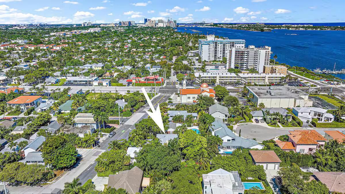 An aerial view shows a residential neighborhood with a white arrow pointing to a house — 4110 Washington Road, West Palm Beach FL 33405, WEST PALM BEACH, FL