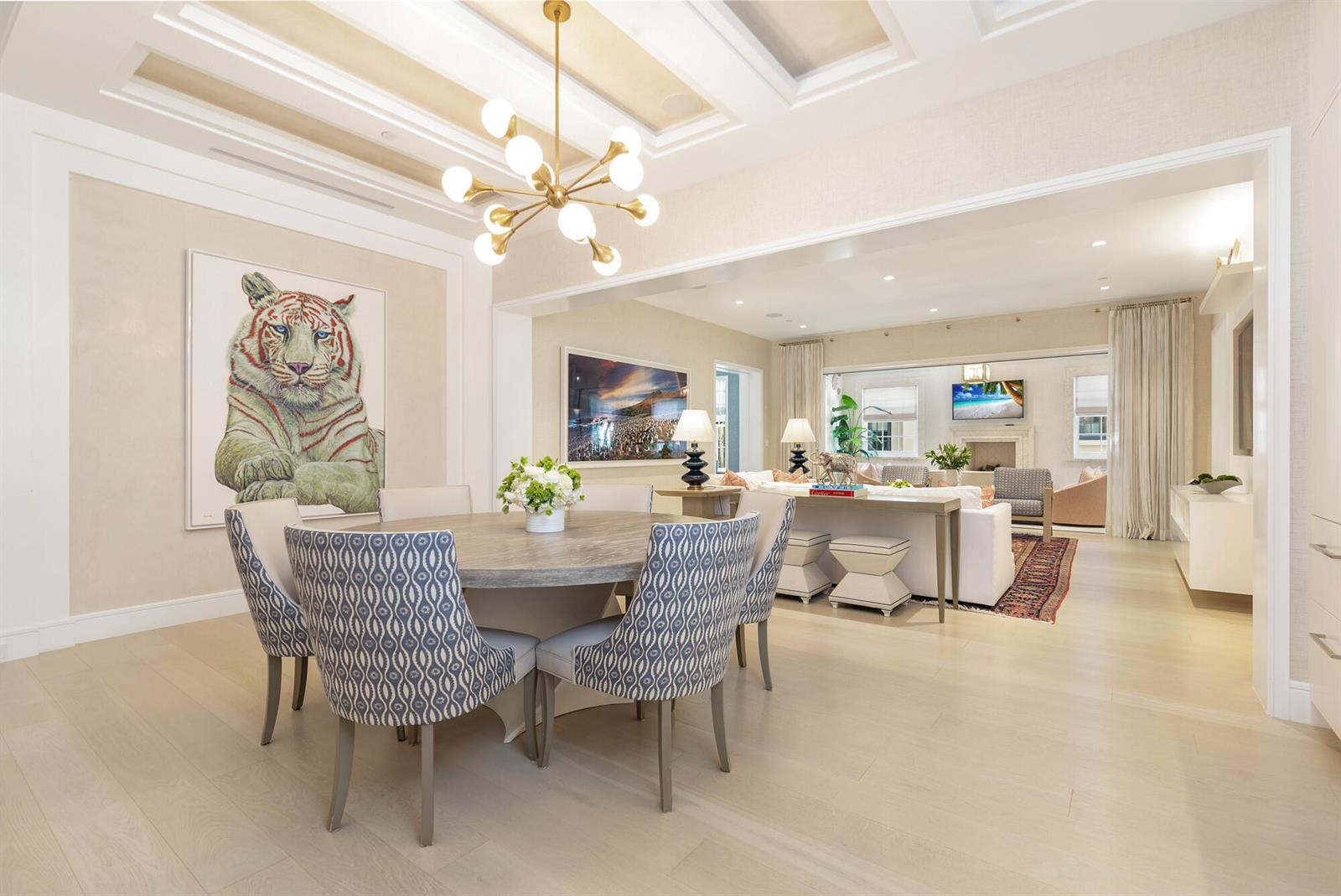 A dining room with a round table and patterned chairs opens into a living area — 5 Via Flagler, Palm Beach FL 33480, PALM BEACH, FL