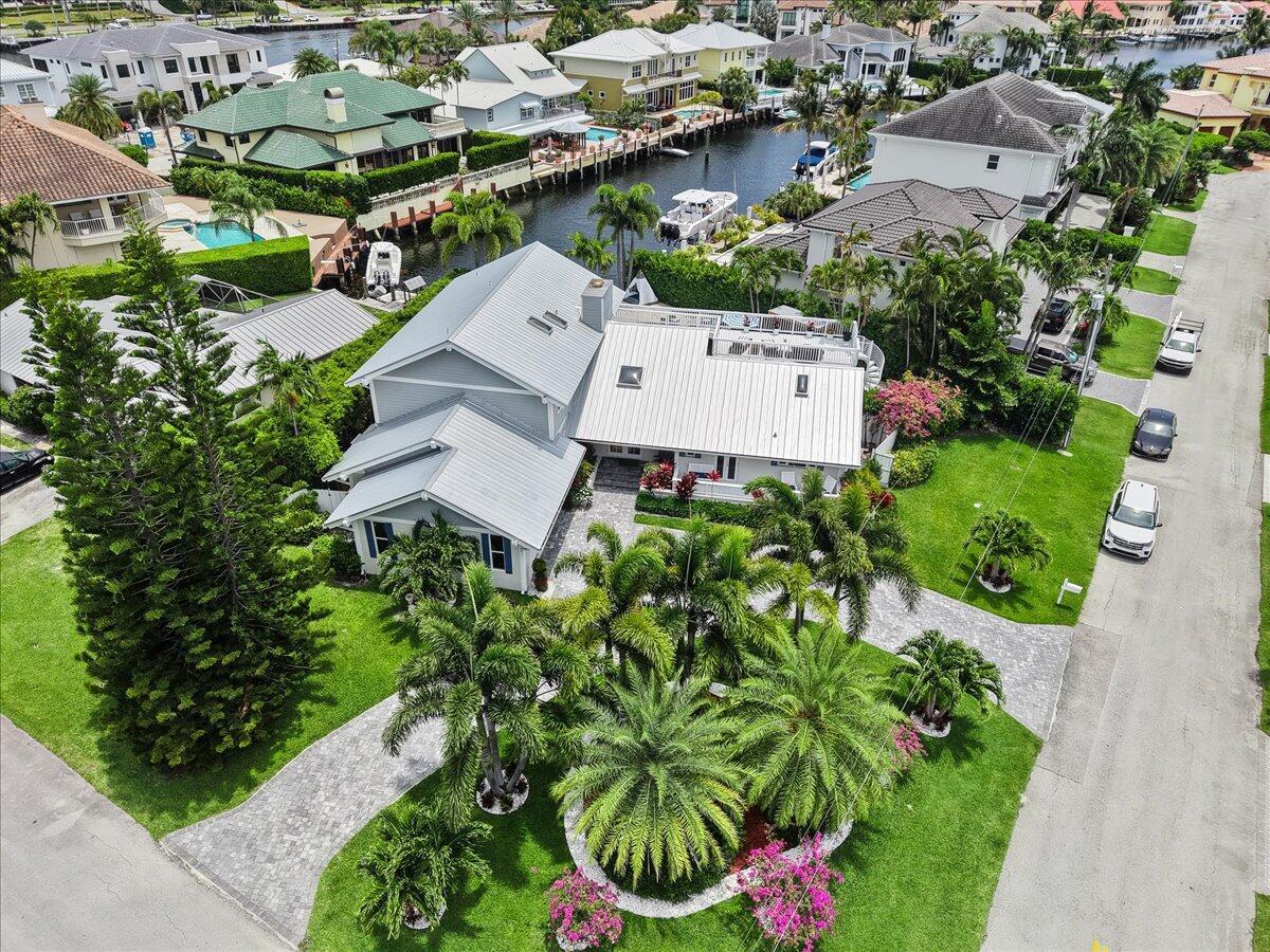 An aerial view of a gray house with a metal roof and a canal dock — 3001 Jasmine Court, Delray Beach FL 33483, DELRAY BEACH, FL