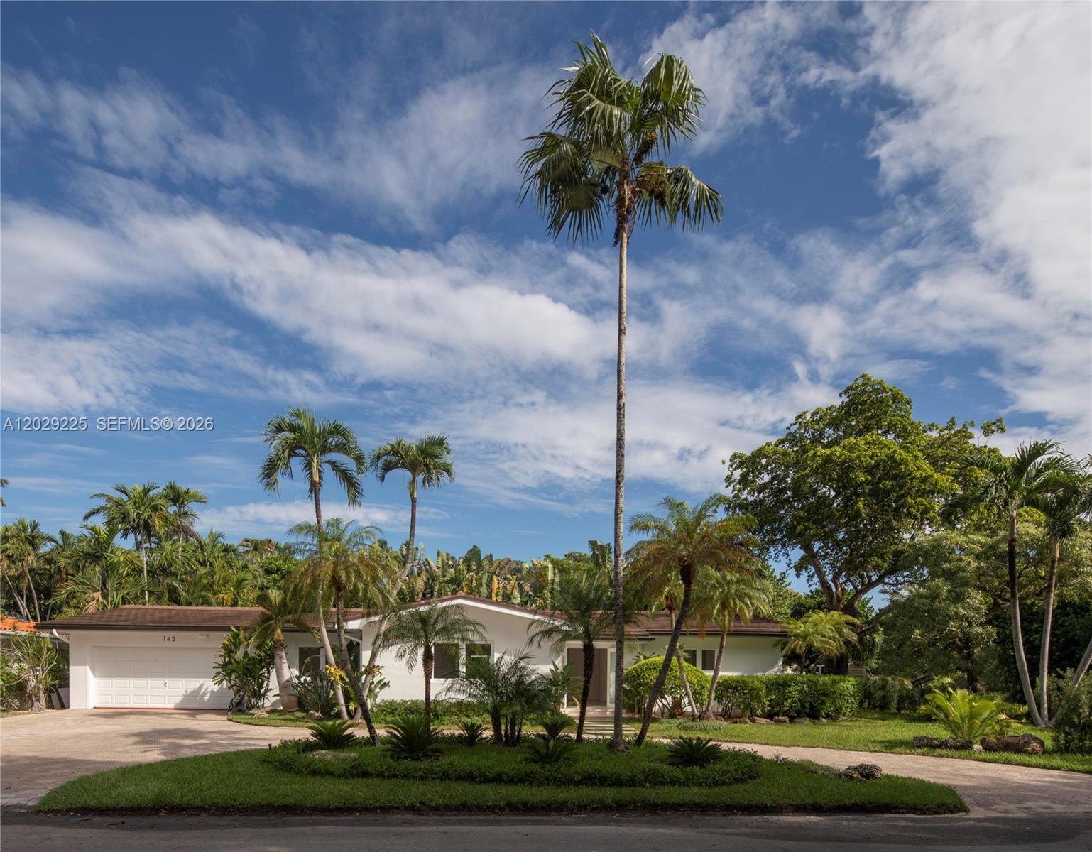 A single-story white house with a brown roof is surrounded by palm trees and landscaping — 145 S Prospect Dr, Coral Gables FL 33133, CORAL GABLES, FL