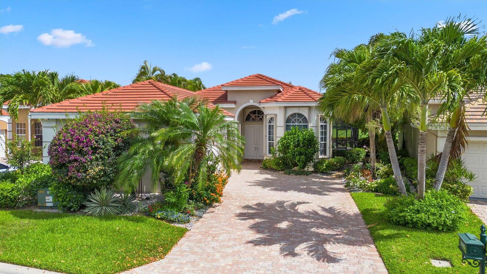 A single-story house with a red tile roof, arched entryway, and a paved driveway — 10911 Royal Devon Way, Lake Worth FL 33449, LAKE WORTH, FL