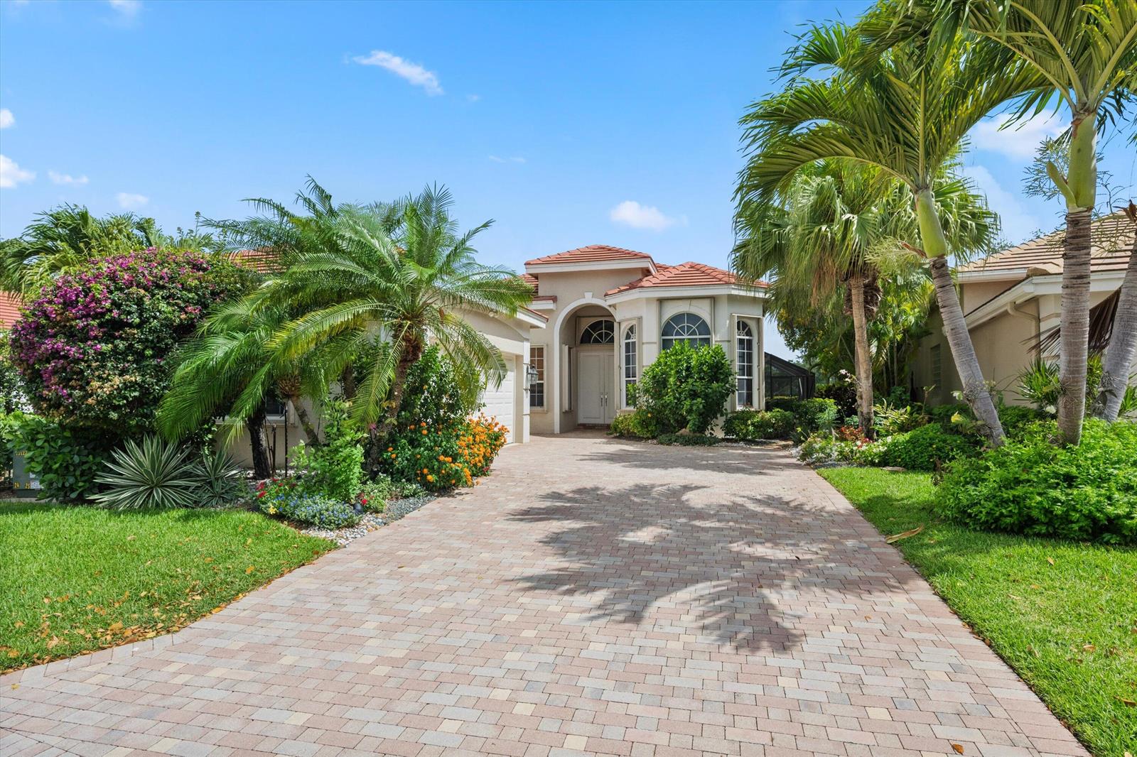 A single-story house with a paved driveway, palm trees, and a tiled roof — 10911 Royal Devon Way, Lake Worth FL 33449, LAKE WORTH, FL