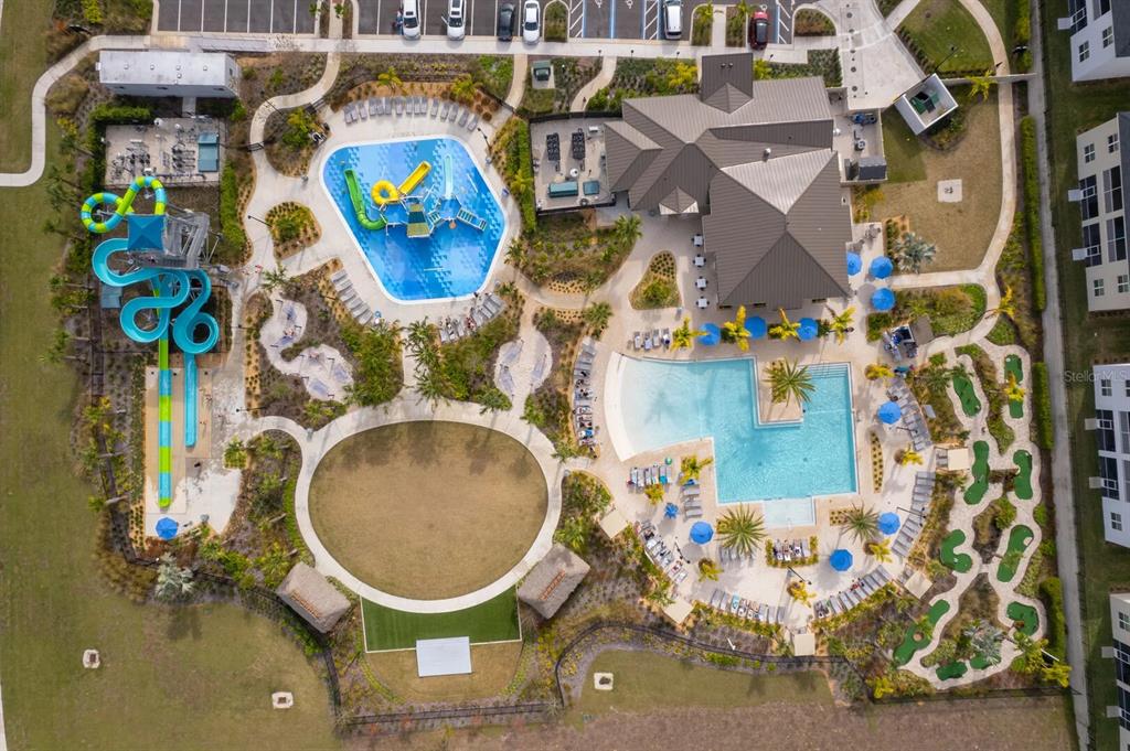 Aerial view of a community amenity center featuring a swimming pool, water slides, and mini-golf — 9056 SOMMERSET HILLS DRIVE, DAVENPORT, FL