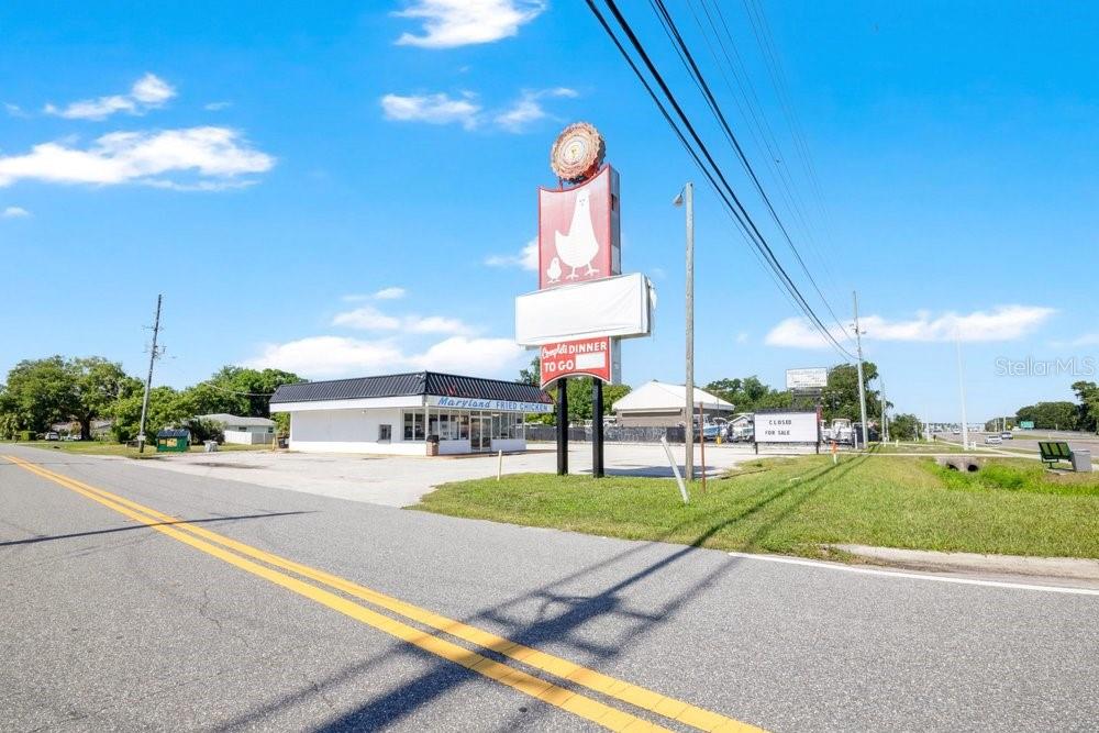 A vacant Maryland Fried Chicken restaurant building with a large roadside sign under a blue sky — 9710 E COLONIAL DRIVE, ORLANDO, FL