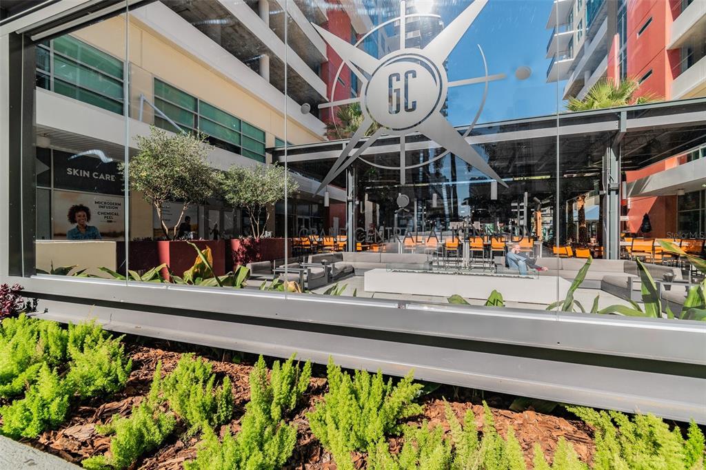 An outdoor courtyard features a lounge area with seating, a fire pit, and glass walls — 1208 E KENNEDY BOULEVARD UNIT 1115, TAMPA, FL