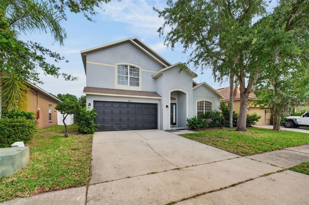 A two-story house with a gray exterior, a two-car garage, and a concrete driveway — 1851 GREAT FALLS WAY, ORLANDO, FL