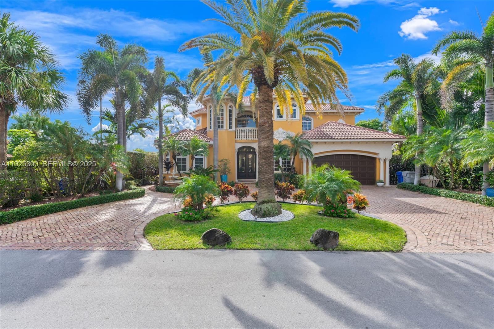 A two-story yellow house with a tile roof and a circular brick driveway — 3406 Leigh Rd, Pompano Beach FL 33062, POMPANO BEACH, FL