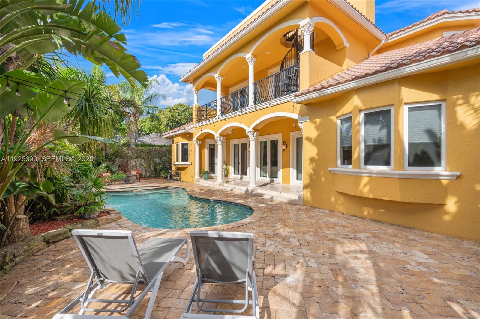 A yellow two-story house features a pool, stone patio, and a second-floor balcony with columns — 3406 Leigh Rd, Pompano Beach FL 33062, POMPANO BEACH, FL