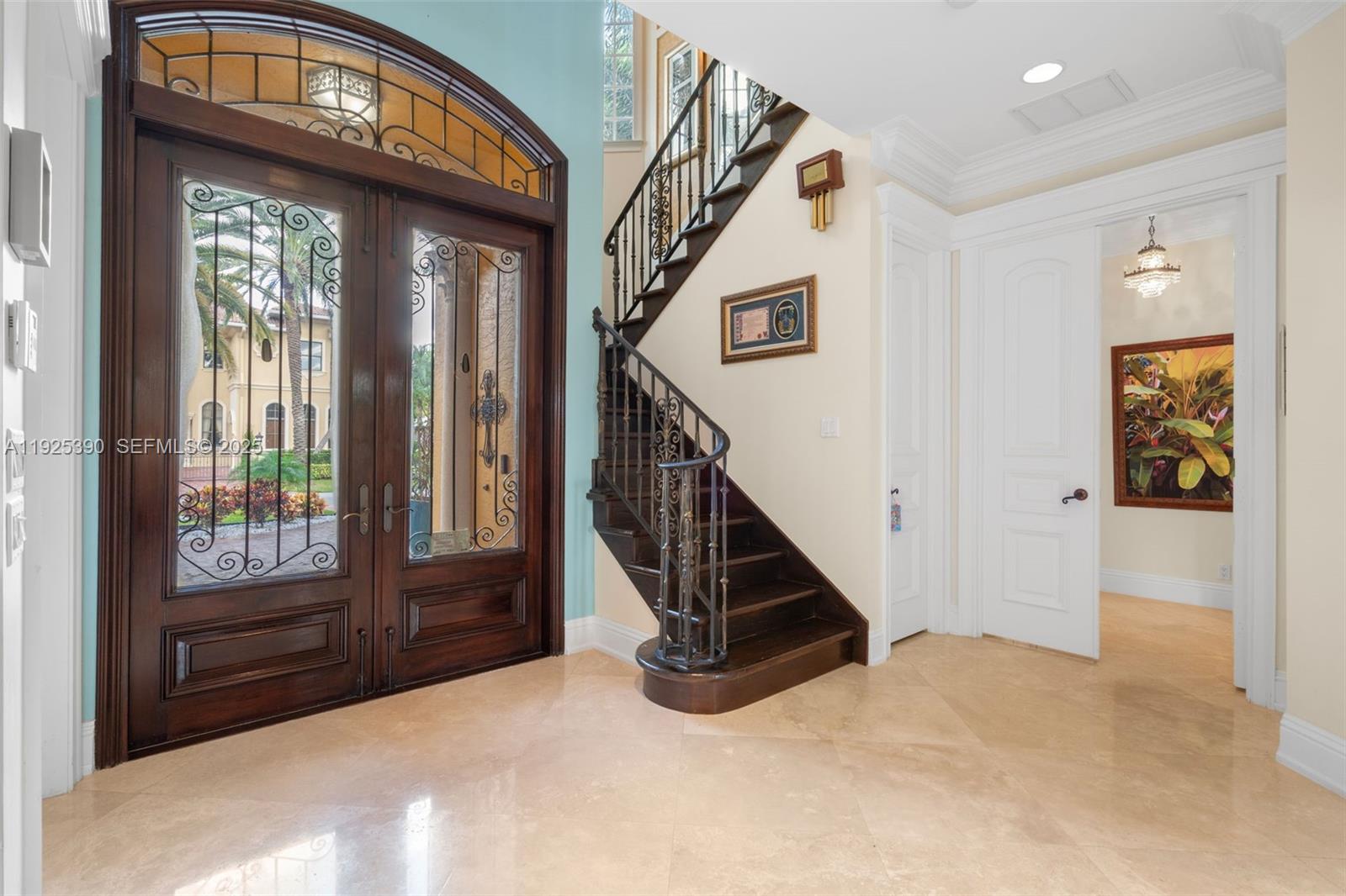An entryway features a grand wooden double door, a curved staircase, and light tile flooring — 3406 Leigh Rd, Pompano Beach FL 33062, POMPANO BEACH, FL