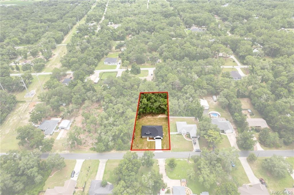 An aerial view shows a single-story house on a rectangular lot outlined in red — 3058 E CROWN DRIVE, INVERNESS, FL