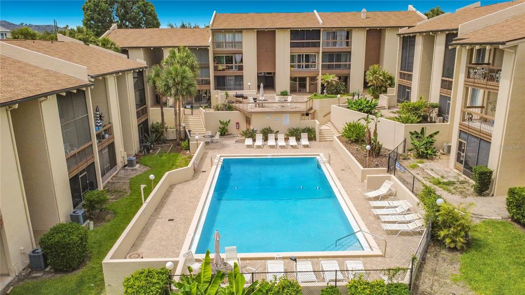 An aerial view of a rectangular swimming pool surrounded by a patio and apartment buildings — 574 ORANGE DRIVE UNIT 78, ALTAMONTE SPRINGS, FL