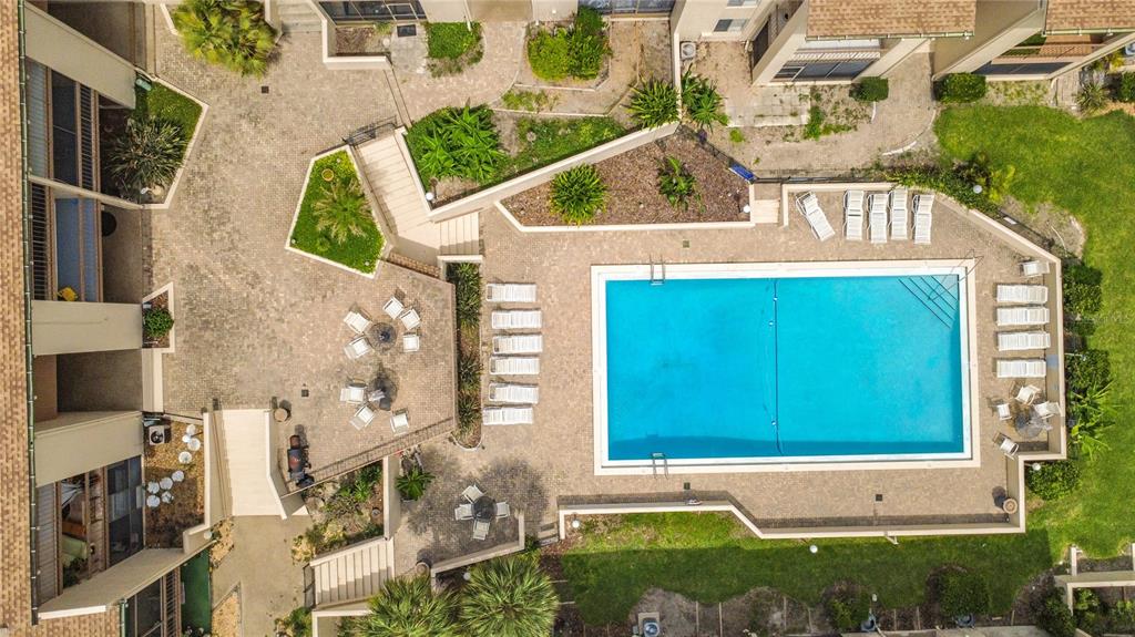 An aerial view shows a rectangular swimming pool surrounded by a paved deck and lounge chairs — 574 ORANGE DRIVE UNIT 78, ALTAMONTE SPRINGS, FL