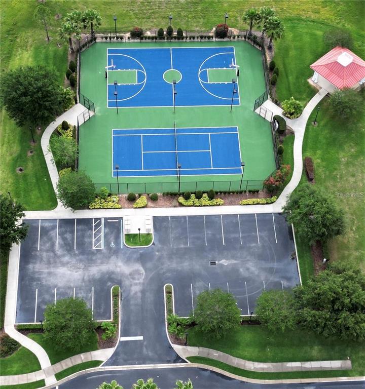 An aerial view shows a basketball court, a tennis court, and a parking lot — 168 FRINGE TREE, LAKE ALFRED, FL