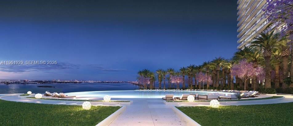 This is a rendering of an infinity pool overlooking a bay at dusk — 480 NE 31st St # 1504, Miami FL 33137, MIAMI, FL