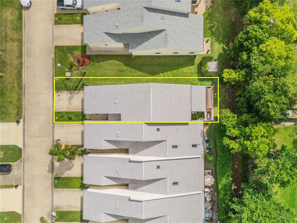 An aerial view shows a row of townhouses with a yellow box highlighting one unit — 2236 DEERWOOD DRIVE, NEW SMYRNA BEACH, FL