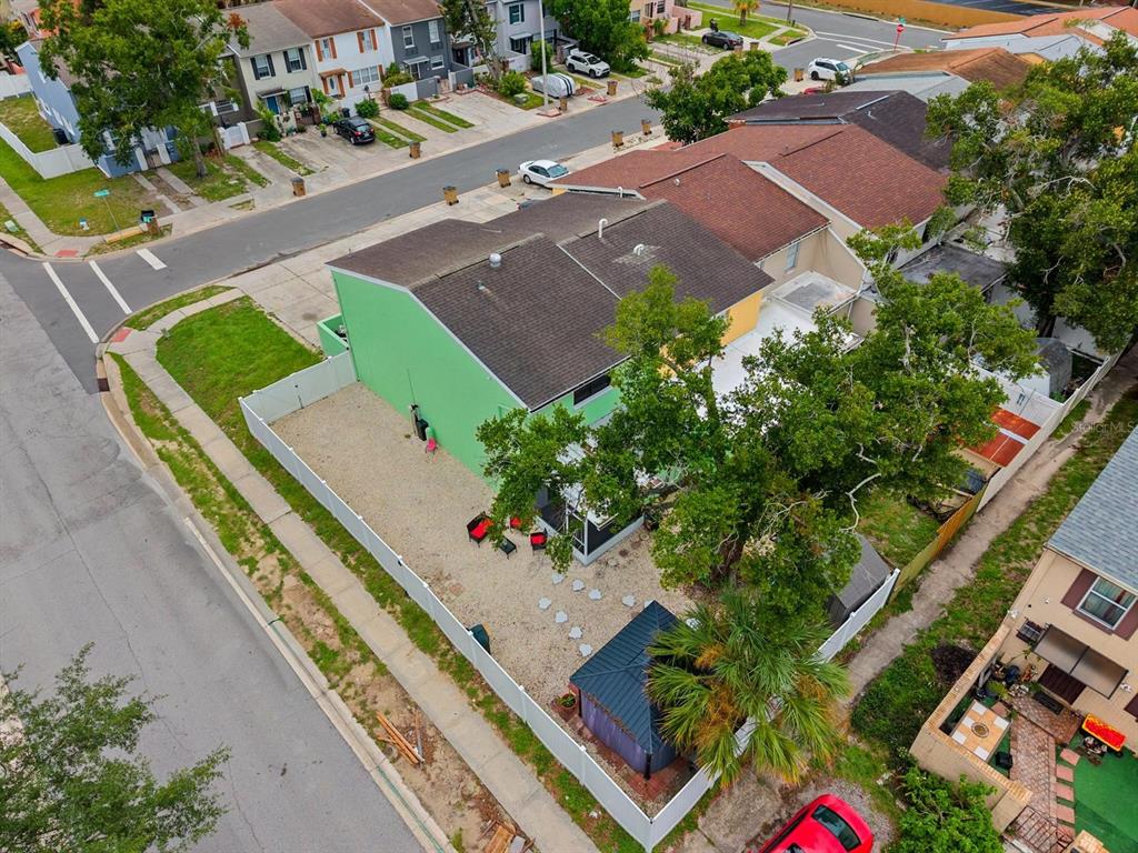 An aerial view shows a green house with a fenced gravel yard and a gazebo — 5220 BLANE DRIVE, TEMPLE TERRACE, FL